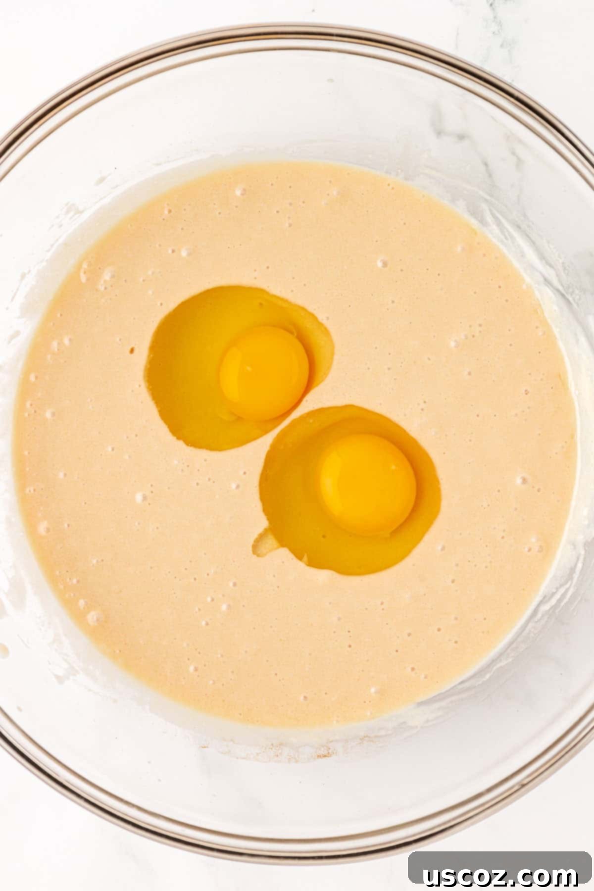 Wholesome Greek Yogurt Cake 9 adding eggs to wet ingredients for cake batter