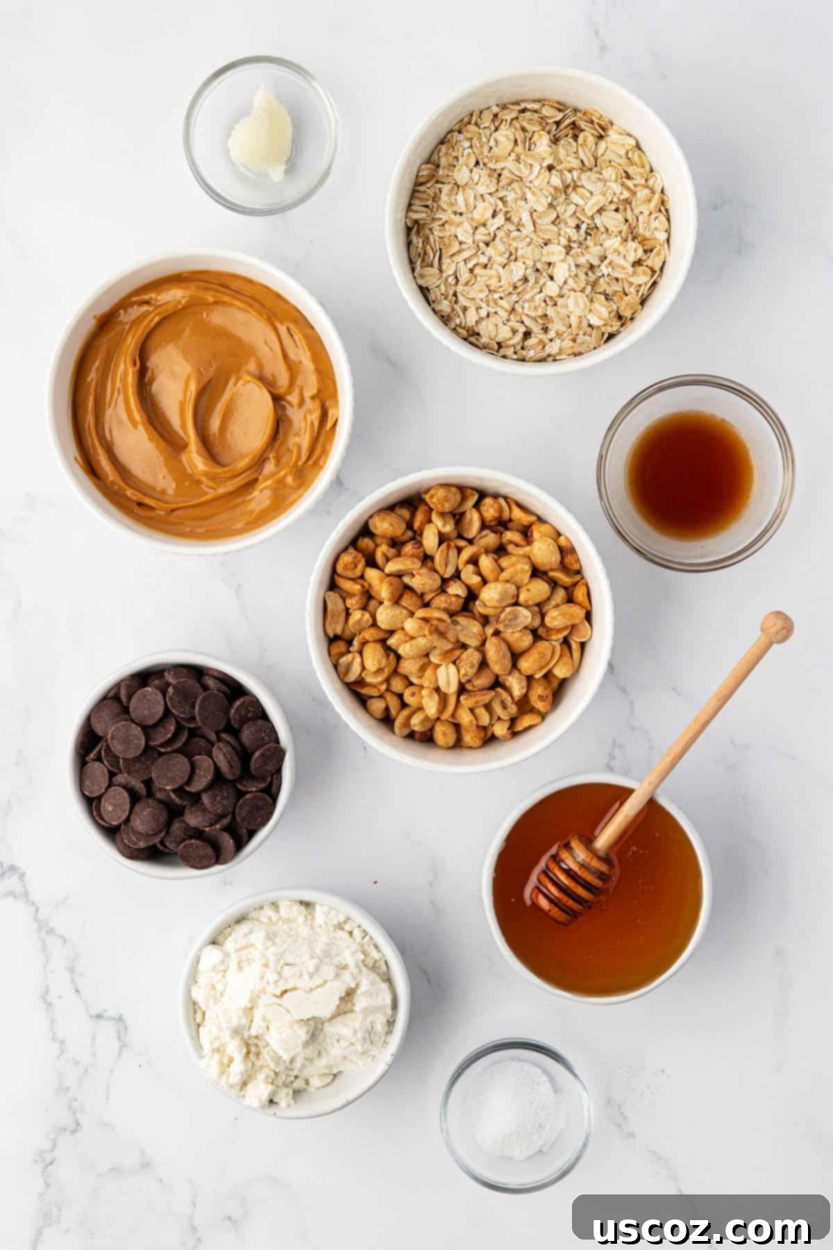 Crunchy Peanut Butter Power Bites 4 All the raw ingredients for peanut butter energy bites laid out, including oats, peanuts, peanut butter, honey, and chocolate chips.