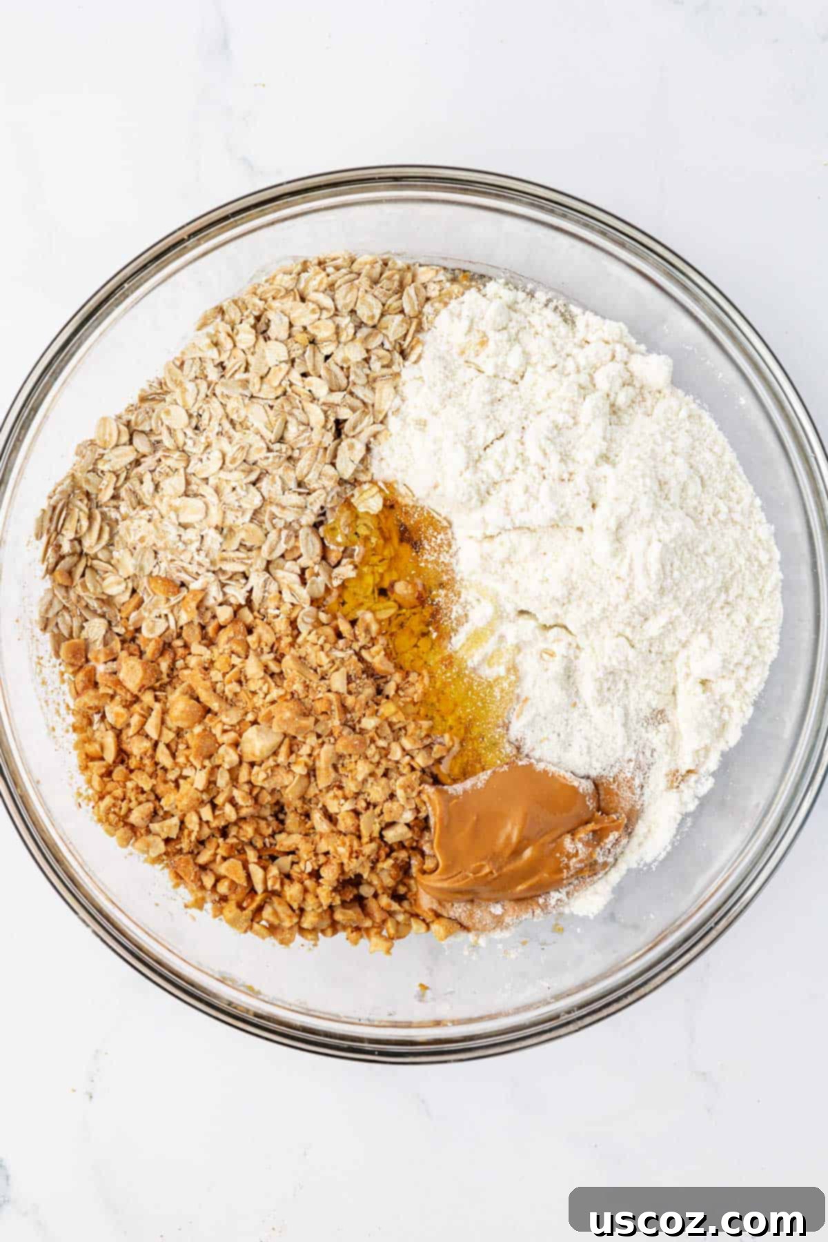 Crunchy Peanut Butter Power Bites 5 Mixing bowl with oats, peanut butter, and other energy bite ingredients before combining.