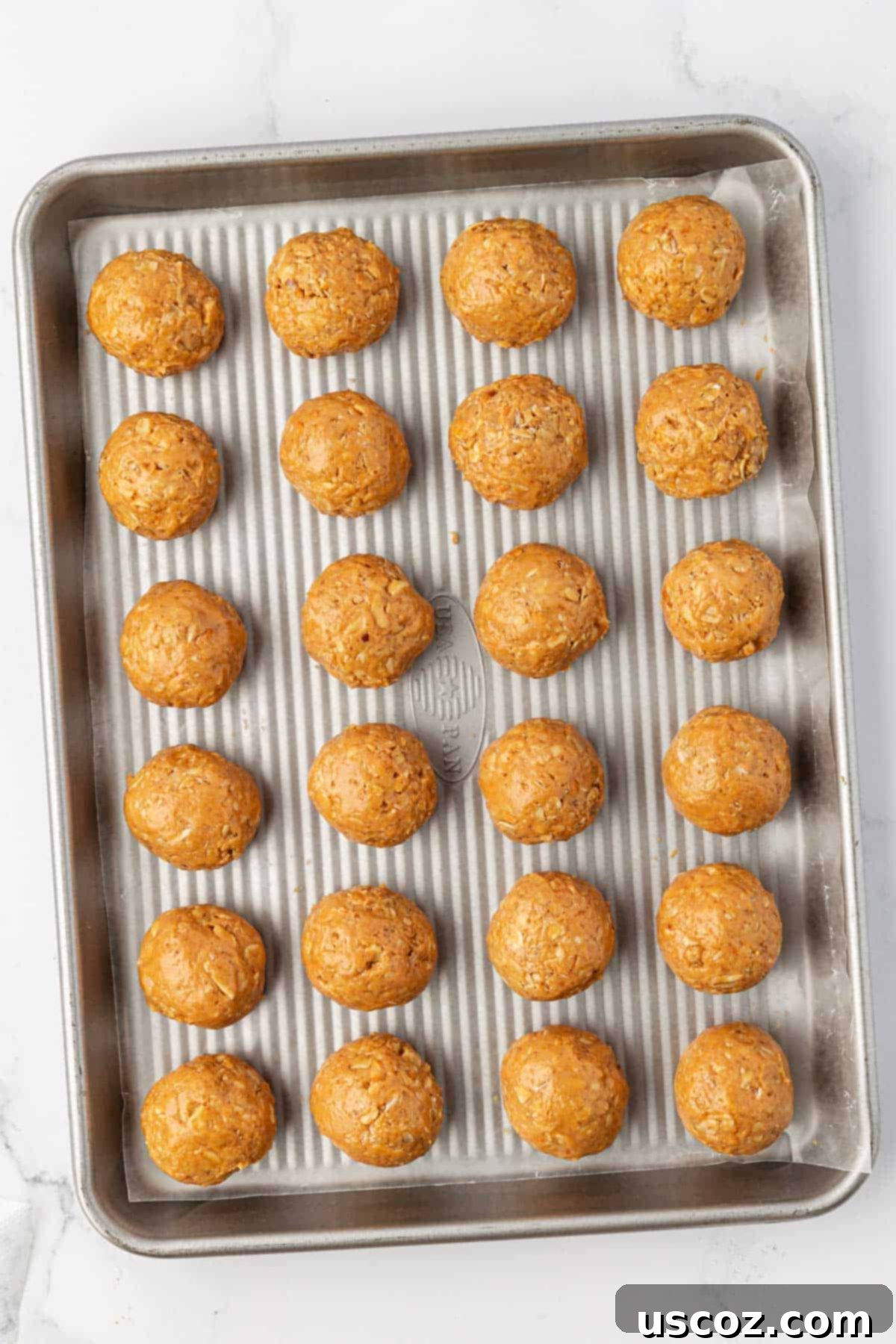 Crunchy Peanut Butter Power Bites 9 A baking sheet with finished peanut butter energy bites, ready for the chocolate drizzle.
