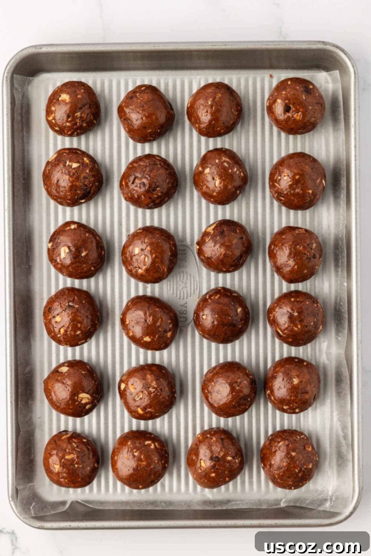 Choco-Cashew Power Bites 13 chocolate cashew energy bites on a baking sheet