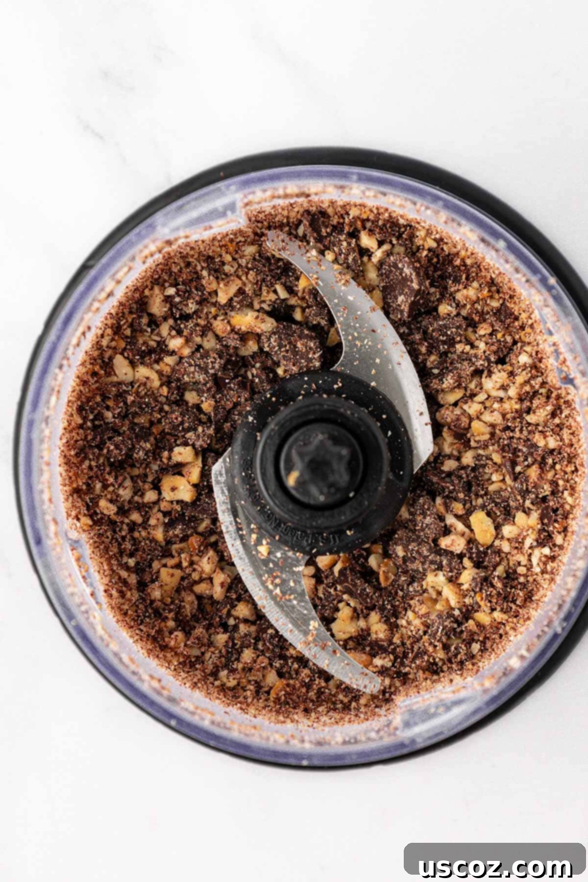 Choco-Cashew Power Bites 8 chopped up dark chocolate chips and cashews in a food processor