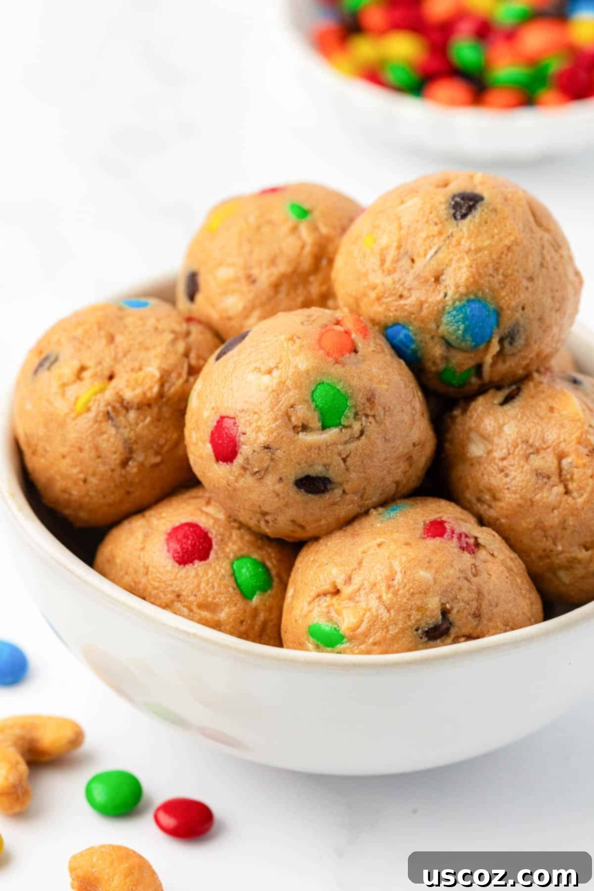 Colorful Chocolate Cashew Crunch Power Bites 2 Delicious M&M Cashew Crunch Energy Bites arranged on a surface