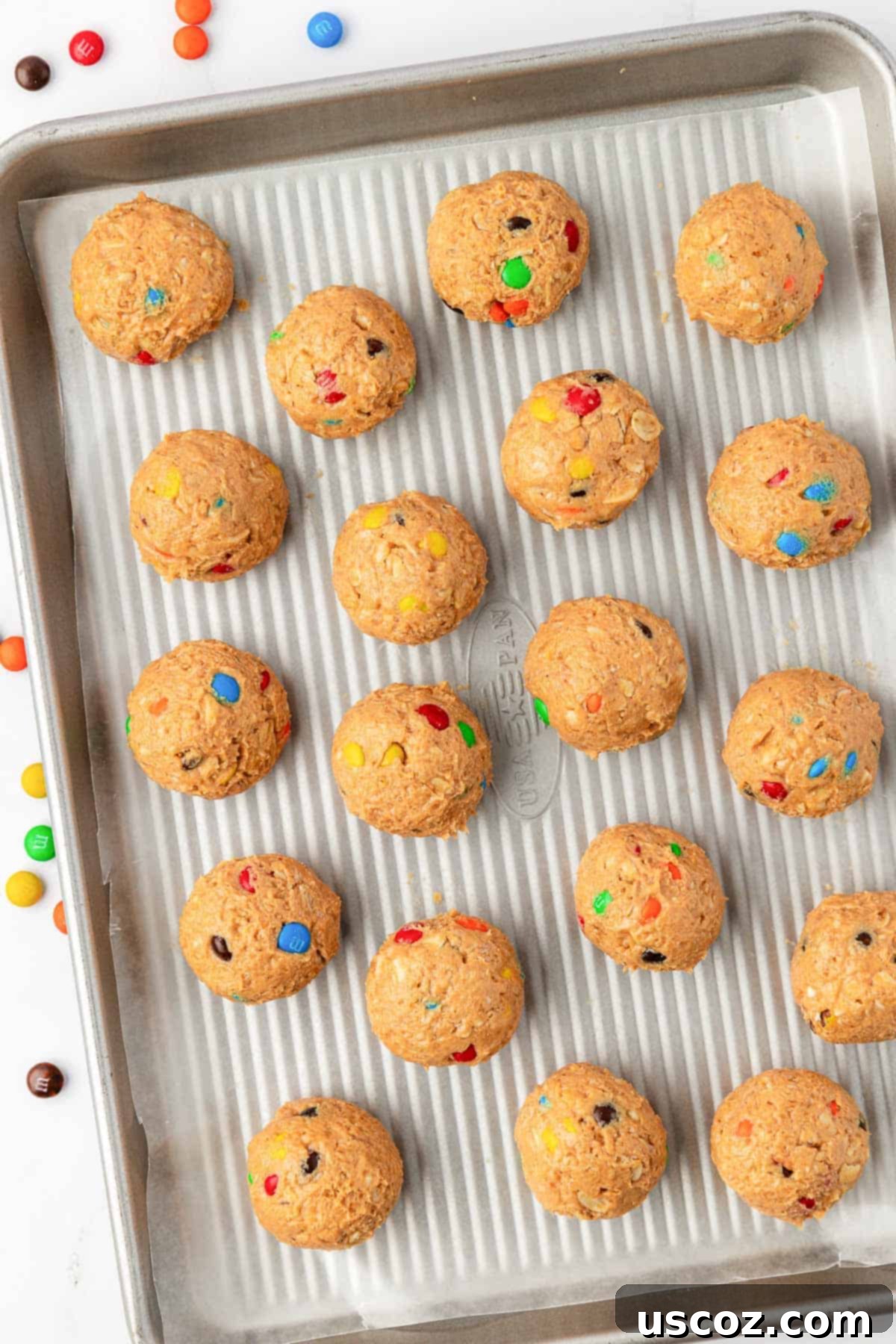 Colorful Chocolate Cashew Crunch Power Bites 7 M&M Cashew Crunch Energy Bites scooped and shaped on a baking sheet