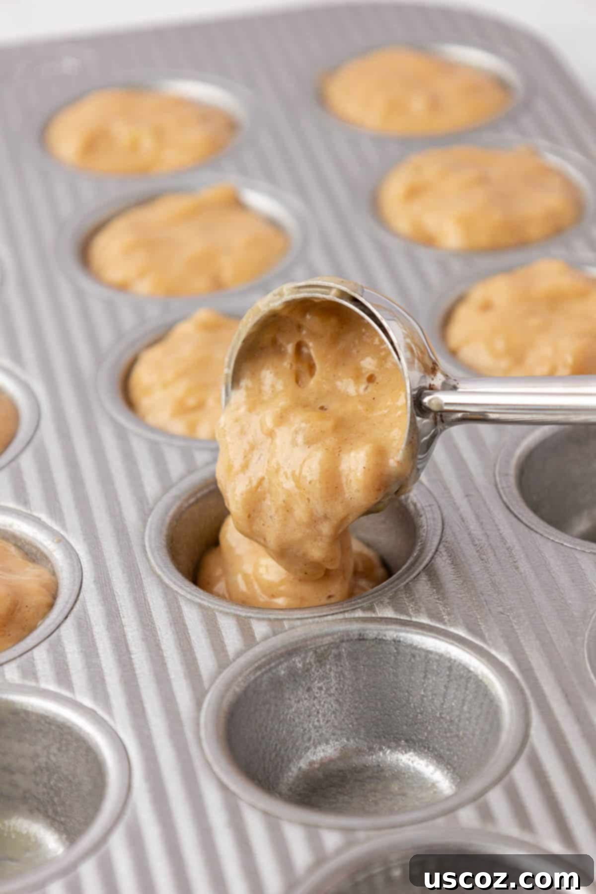 Protein-Rich Banana Muffin Bites 15 pouring the muffin batter into a mini muffin tin