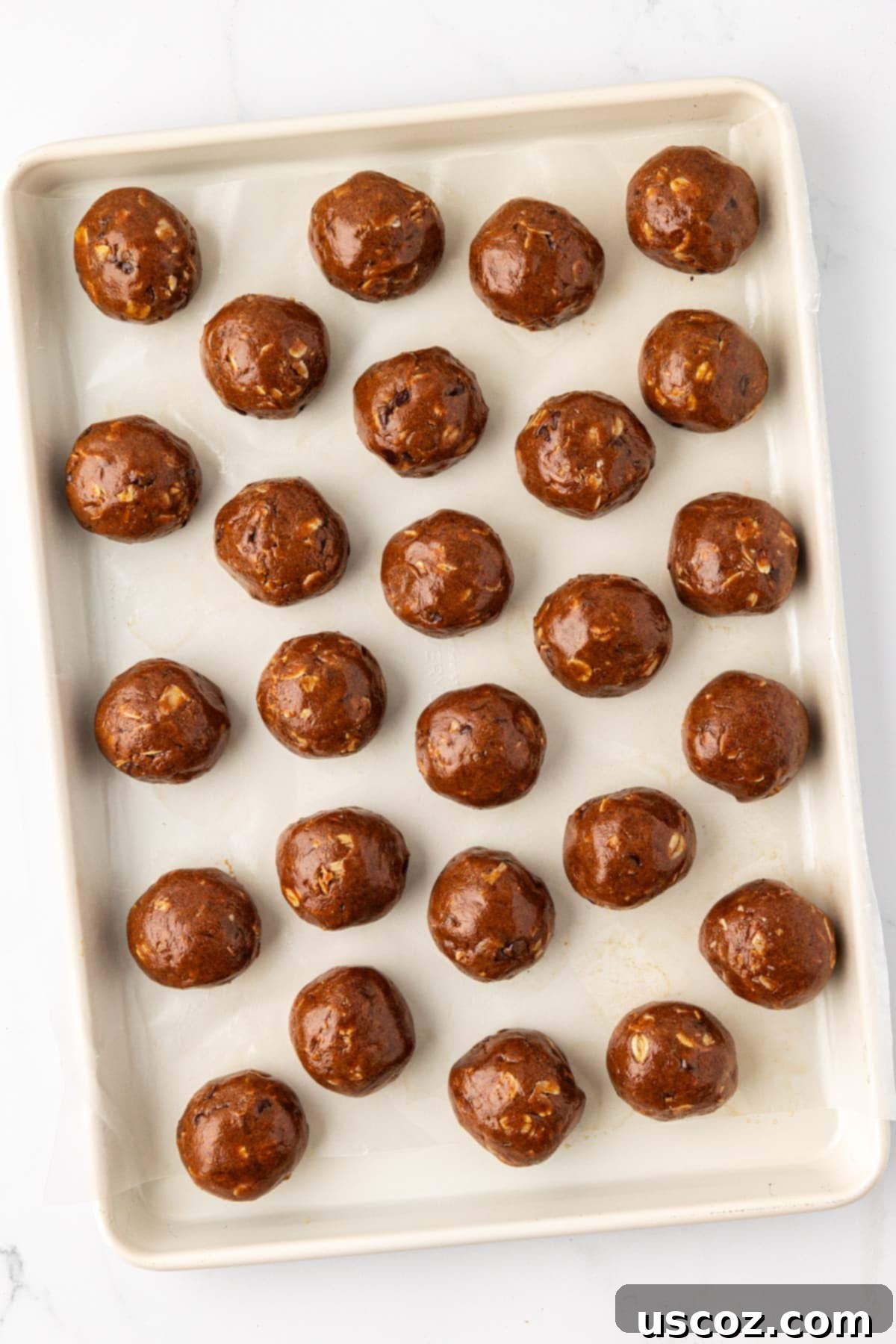 Espresso Boost Bites 9 Hands rolling an espresso energy bite on a baking sheet lined with wax paper