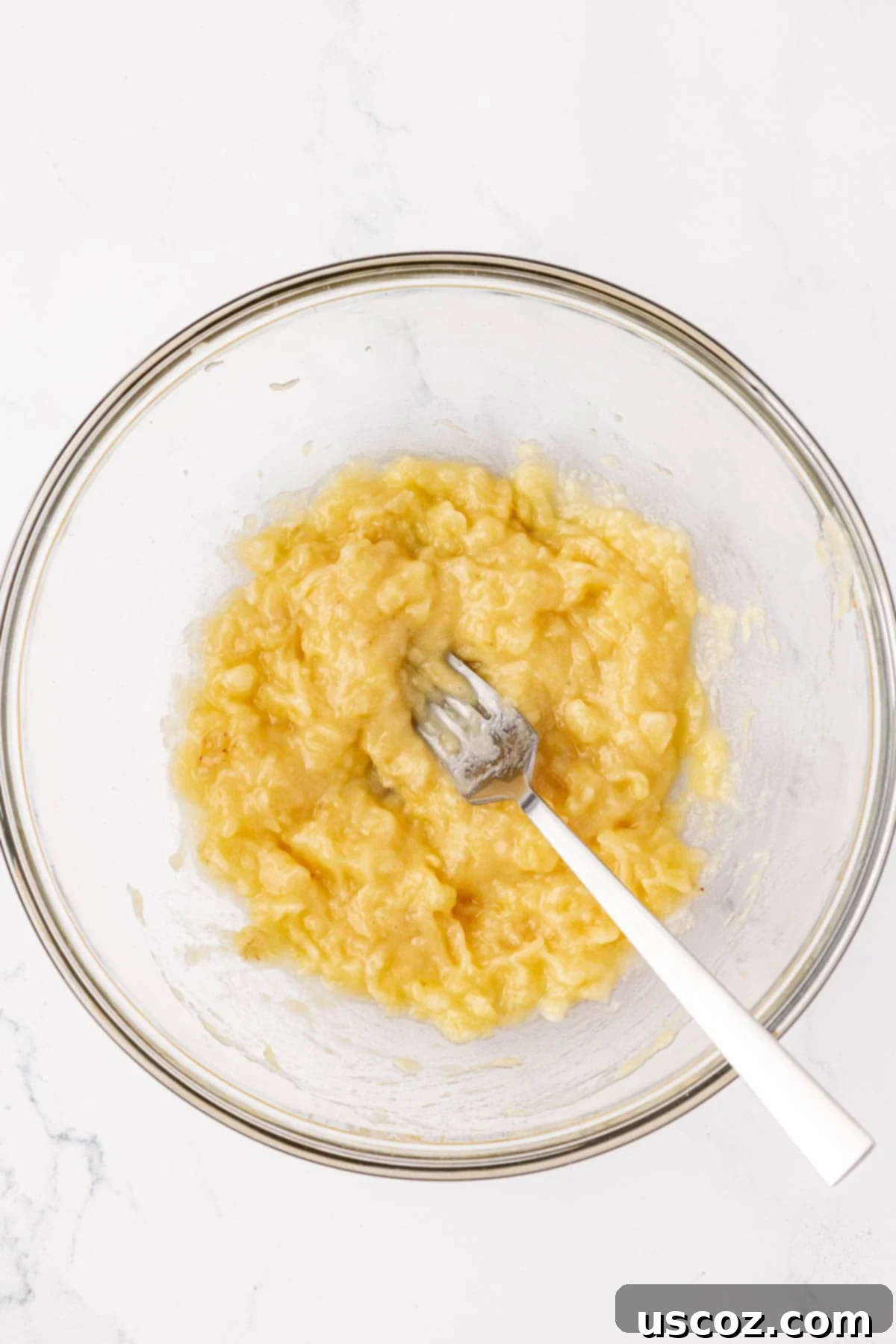 Alphabet Mini Muffins 8 mashed banana in a mixing bowl, smooth and ready