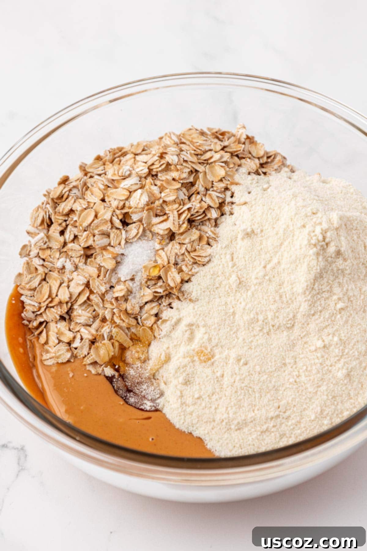 Power-Packed Protein Granola Bars 5 Adding honey, protein powder, salt, and rolled oats to the melted peanut butter
