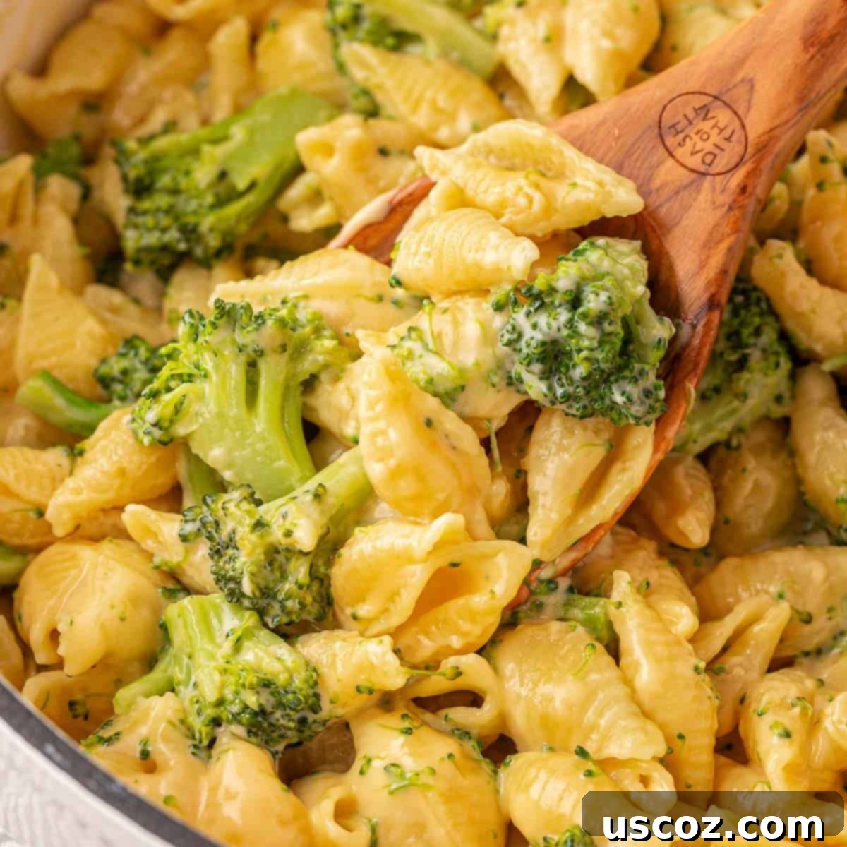 Creamy Broccoli Mac and Cheese 19 scooping broccoli mac and cheese from the pan