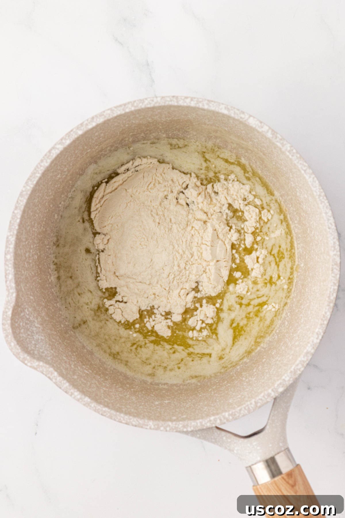 adding flour to melted butter