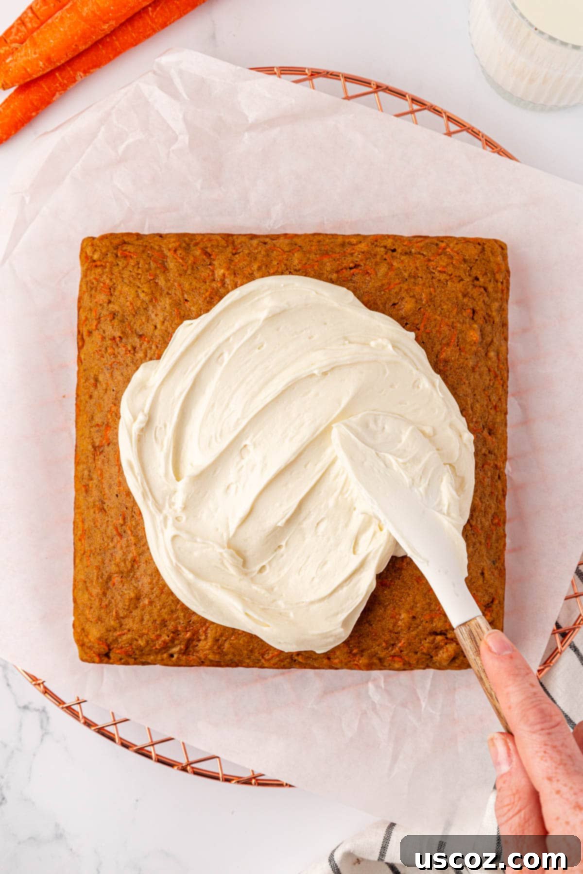Wholesome Carrot Cake Bars 17 spreading the cream cheese frosting over the top of the carrot cake