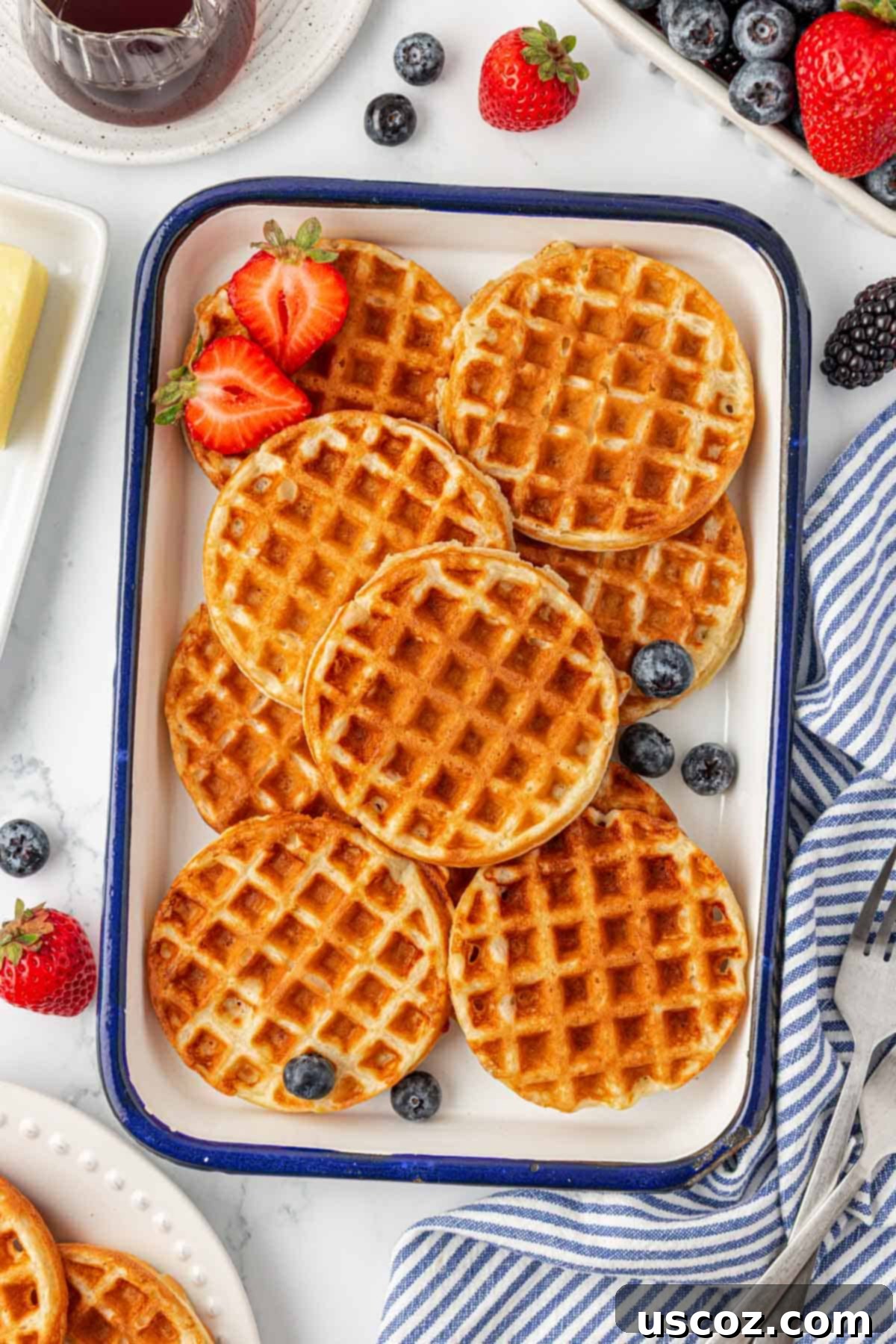 A close-up shot of a Greek yogurt waffle with a bite taken out, showing its light and airy interior.