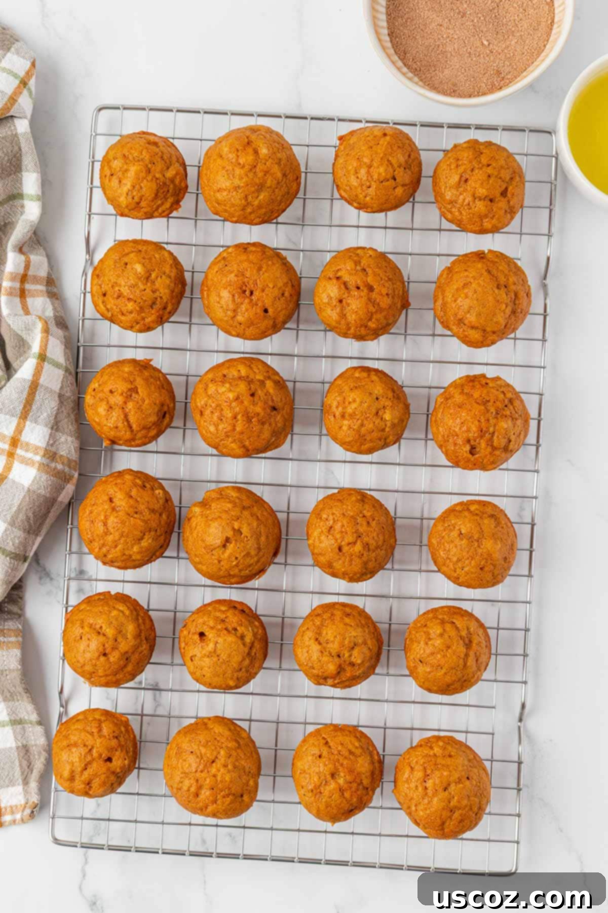 warm pumpkin donut mini muffins on a cooling rack