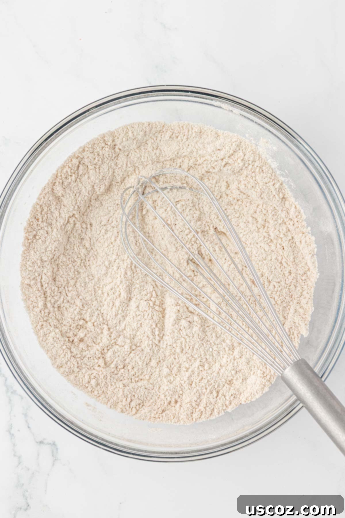 whisking dry ingredients together for pumpkin muffins