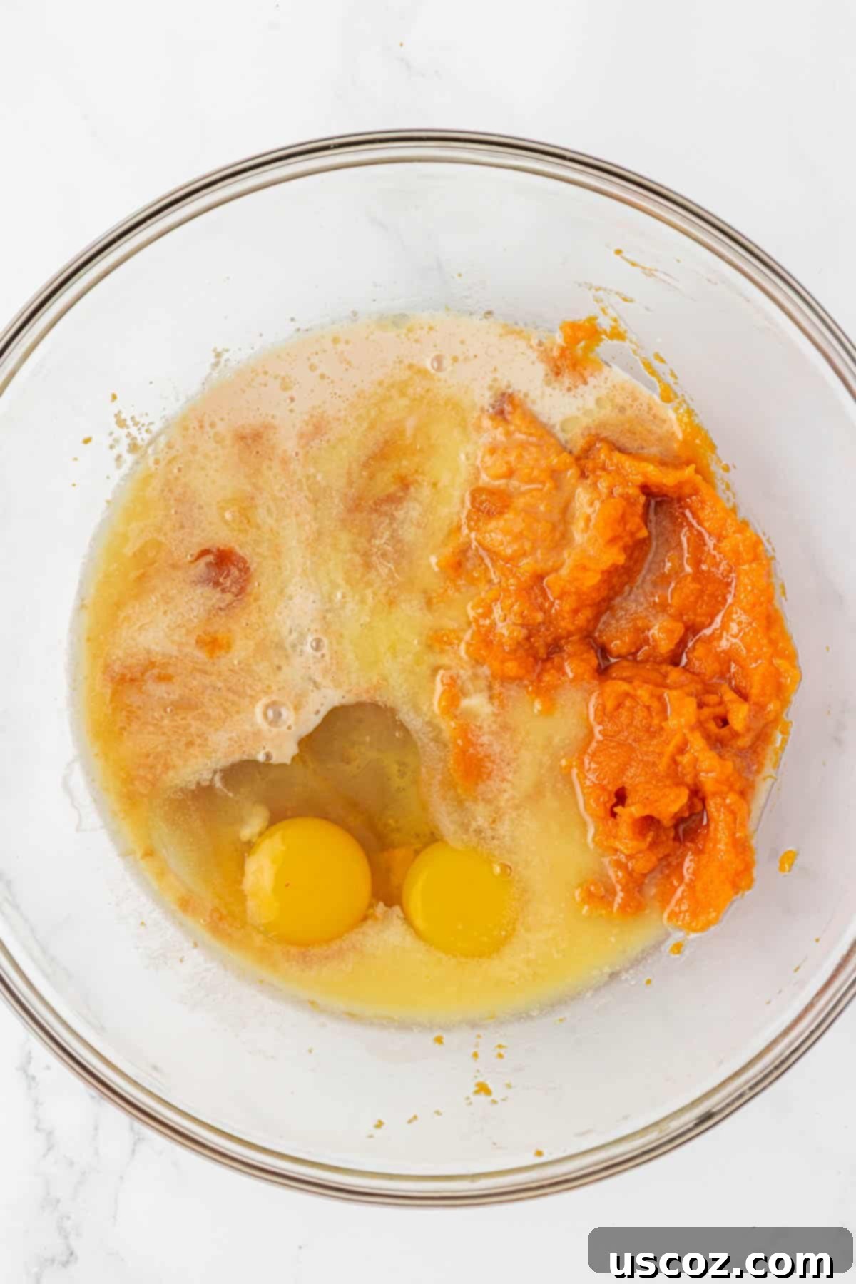 wet ingredients in a bowl for pumpkin donut mini muffins