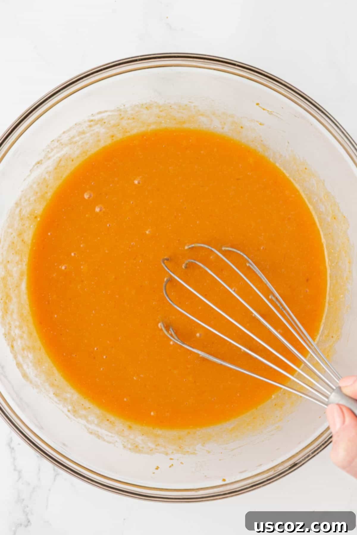 whisking wet ingredients for pumpkin muffin batter