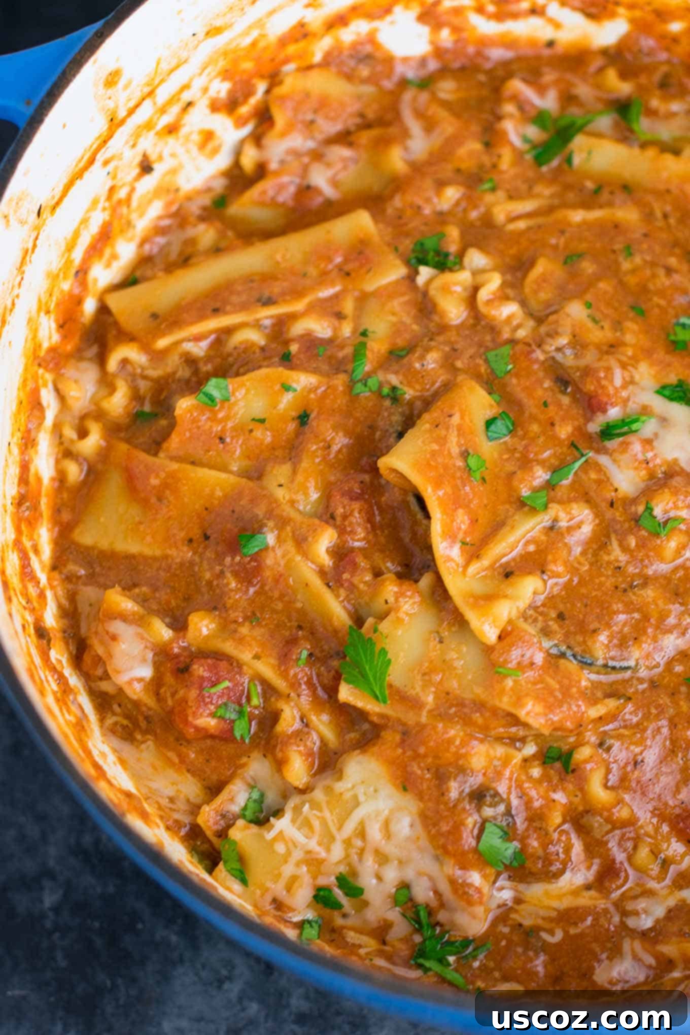 Easy One-Pot Lasagna Soup 6 Broken lasagna noodles simmering in a rich tomato-based soup in a Dutch oven