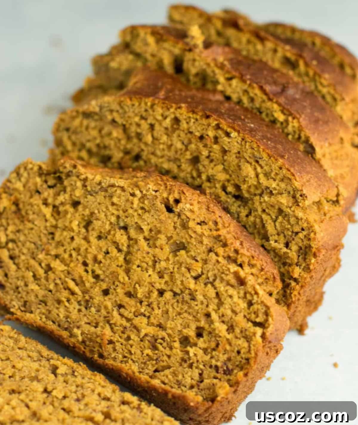 Wholesome Spiced Pumpkin and Banana Bread 10 Artfully arranged slices of pumpkin bread, stacked and ready for serving.