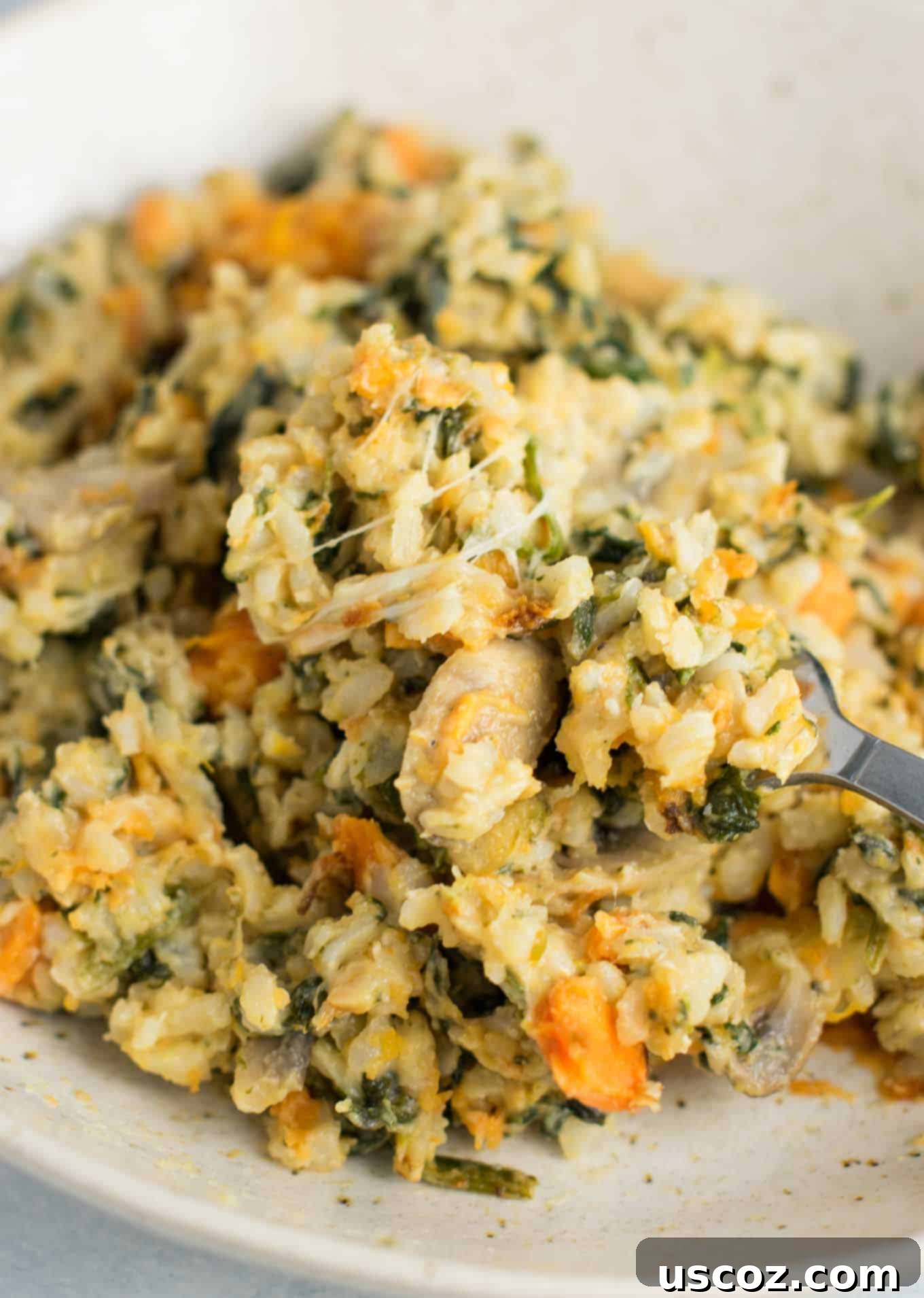 Sweet Potato Brown Rice Casserole made with greek yogurt, mushrooms, spinach, mozzarella, parmesan, and cheddar cheese - a hearty vegetarian comfort food recipe. No cream of anything soup! #casserole #vegetarian #sweetpotatobrownricecasserole #brownrice