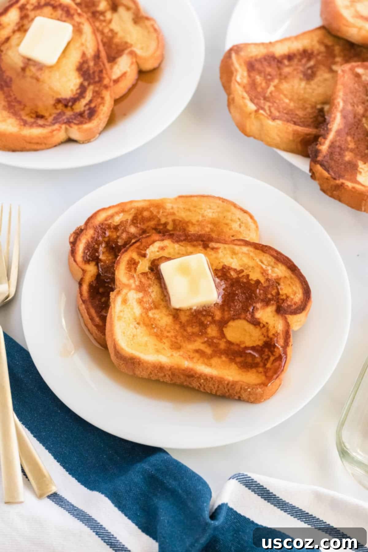 Festive Eggnog French Toast 9 Festive Eggnog French Toast with warm maple syrup and a sprinkle of powdered sugar, elegantly presented for holiday breakfast or brunch