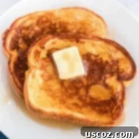 Festive Eggnog French Toast 10 eggnog french toast on a plate topped with butter and maple syrup