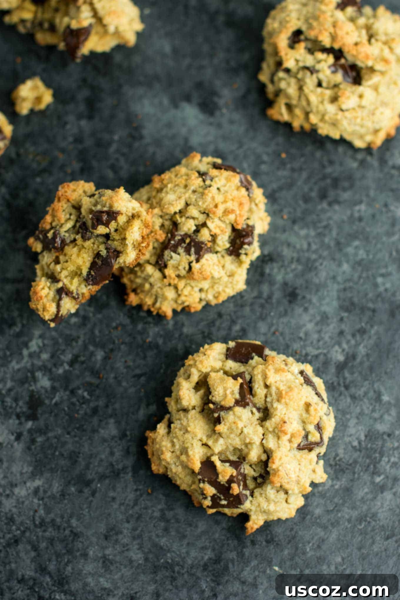 A stack of warm Gluten-Free Oatmeal Chocolate Chip Cookies, invitingly soft and delicious.