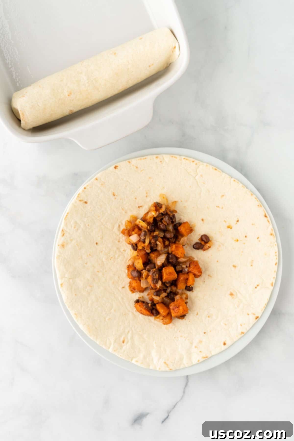 Southwestern Sweet Potato Black Bean Enchiladas 11 Spoonful of enchilada filling being added to a soft taco shell