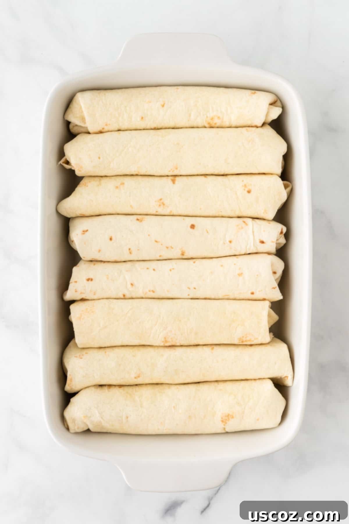 Southwestern Sweet Potato Black Bean Enchiladas 12 Rolled enchiladas arranged neatly seam-side down in a baking dish