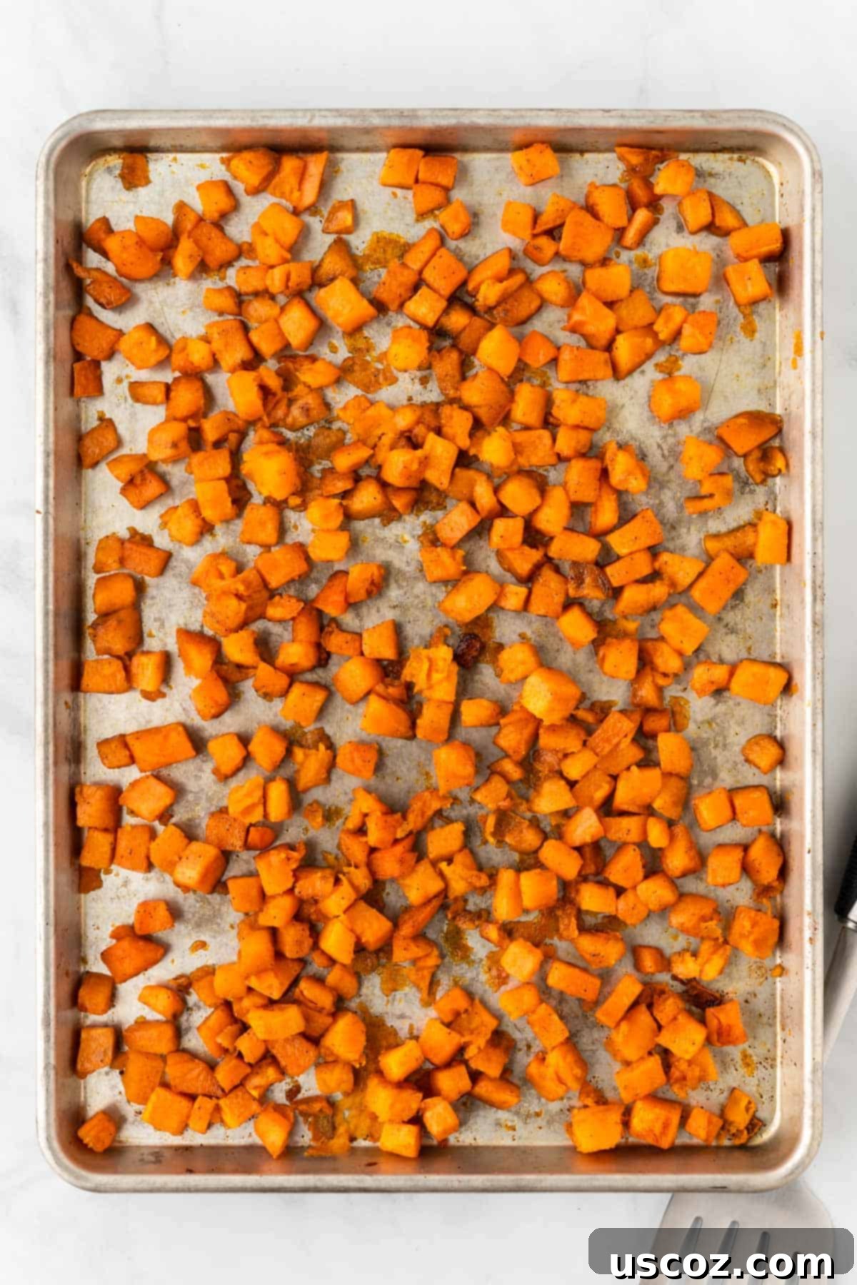 Southwestern Sweet Potato Black Bean Enchiladas 6 Roasted cubed sweet potatoes on a baking sheet, golden and tender