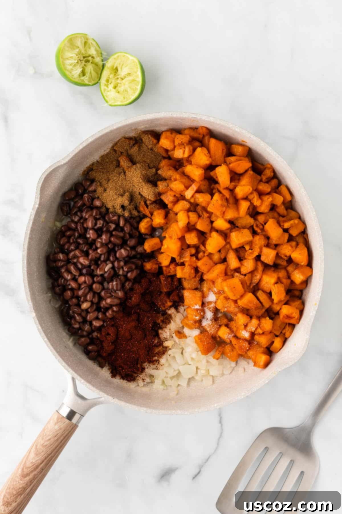 Southwestern Sweet Potato Black Bean Enchiladas 9 Adding roasted sweet potatoes, black beans, and spices to a skillet for enchilada filling