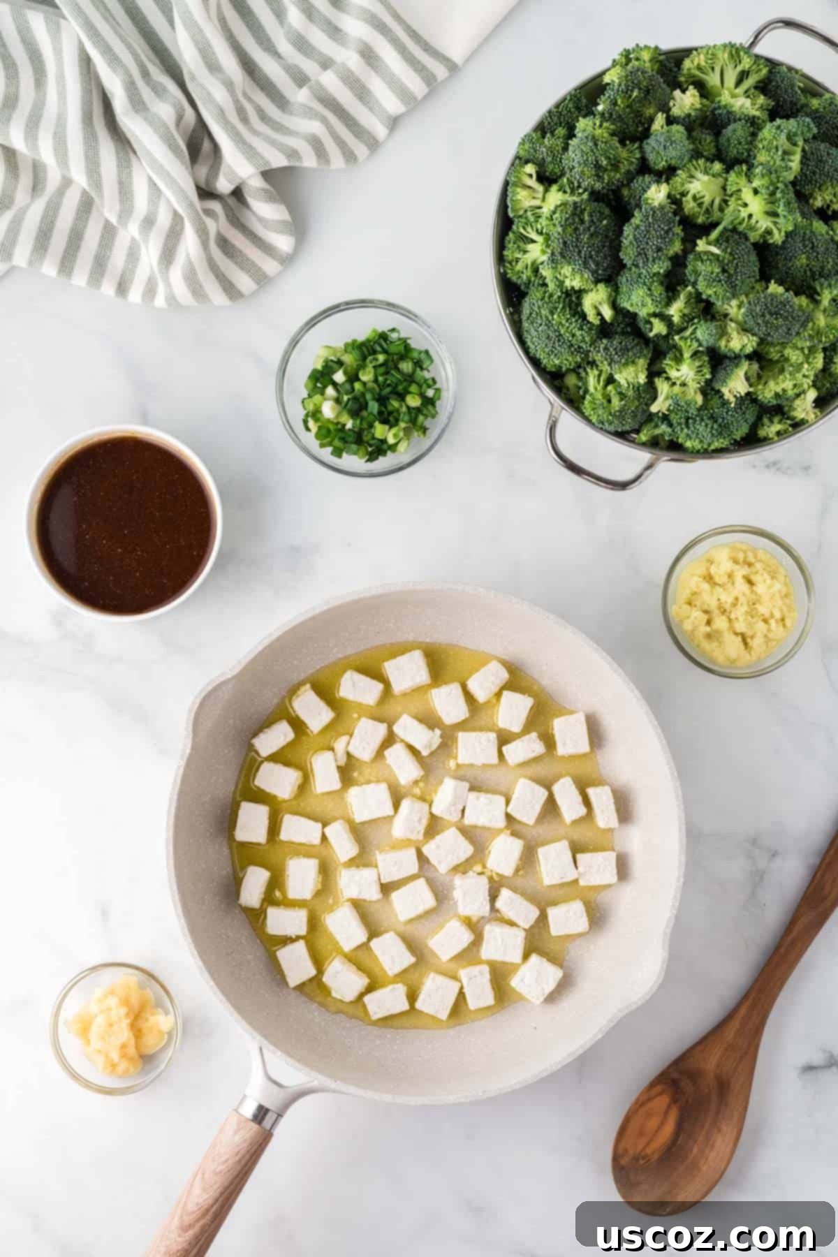 Flavorful Tofu and Broccoli Stir-Fry 8 tofu cooking in a skillet surrounded with the other recipe ingredients