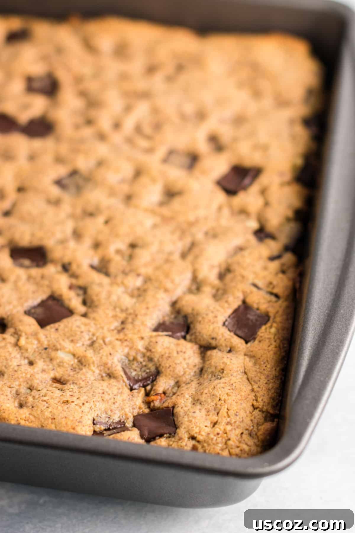 Decadent Dark Chocolate Pecan Cookie Bars 3 Freshly baked gluten-free dark chocolate pecan cookie bars in a square baking dish