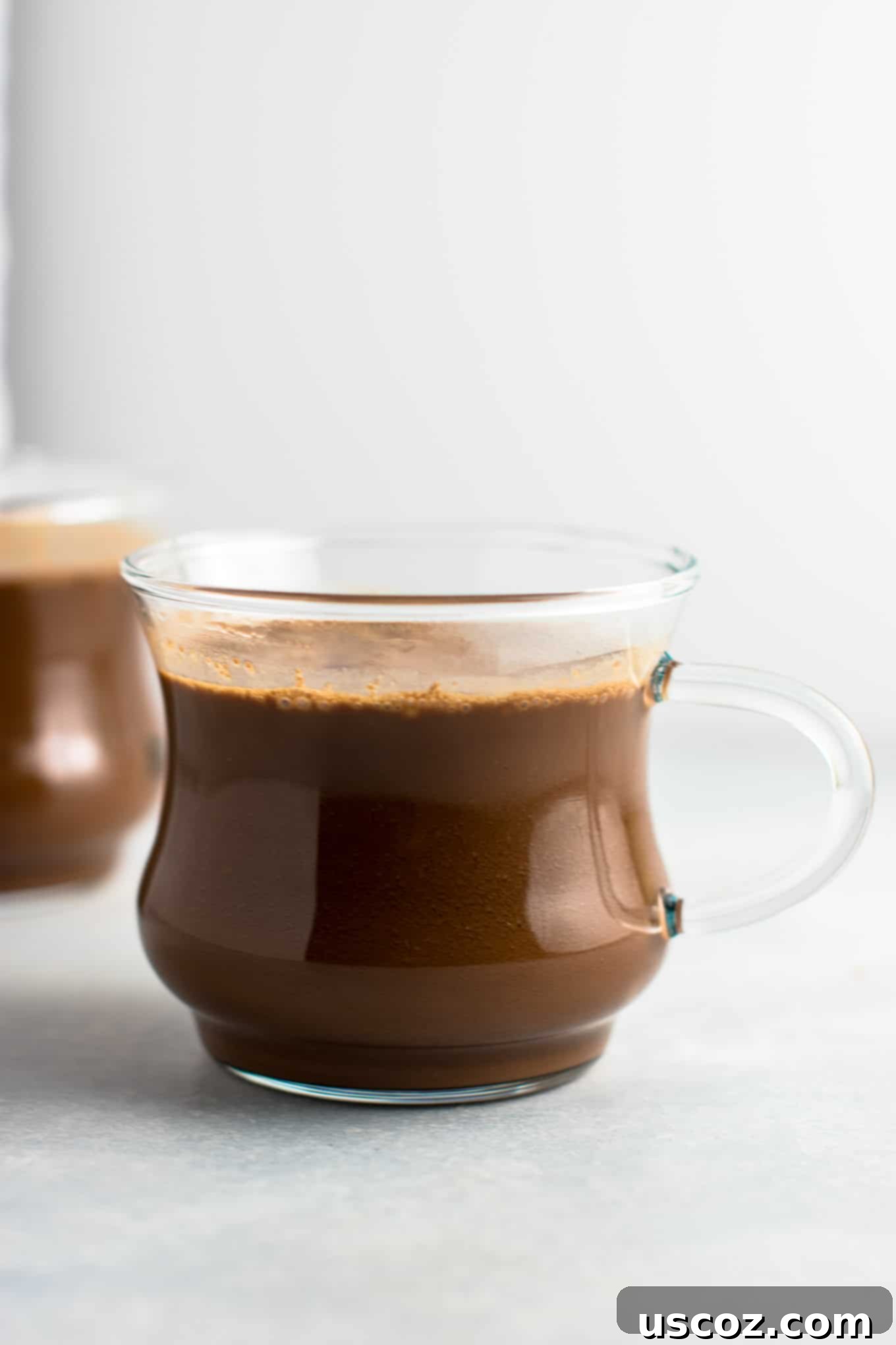 Creamy Vegan Hot Chocolate 4 Easy 4-Ingredient vegan hot chocolate recipe made with almond milk. Dairy-free, gluten-free, and vegan. The perfect cozy winter drink! #vegan #hotchocolate #drinks #christmas #dairyfree