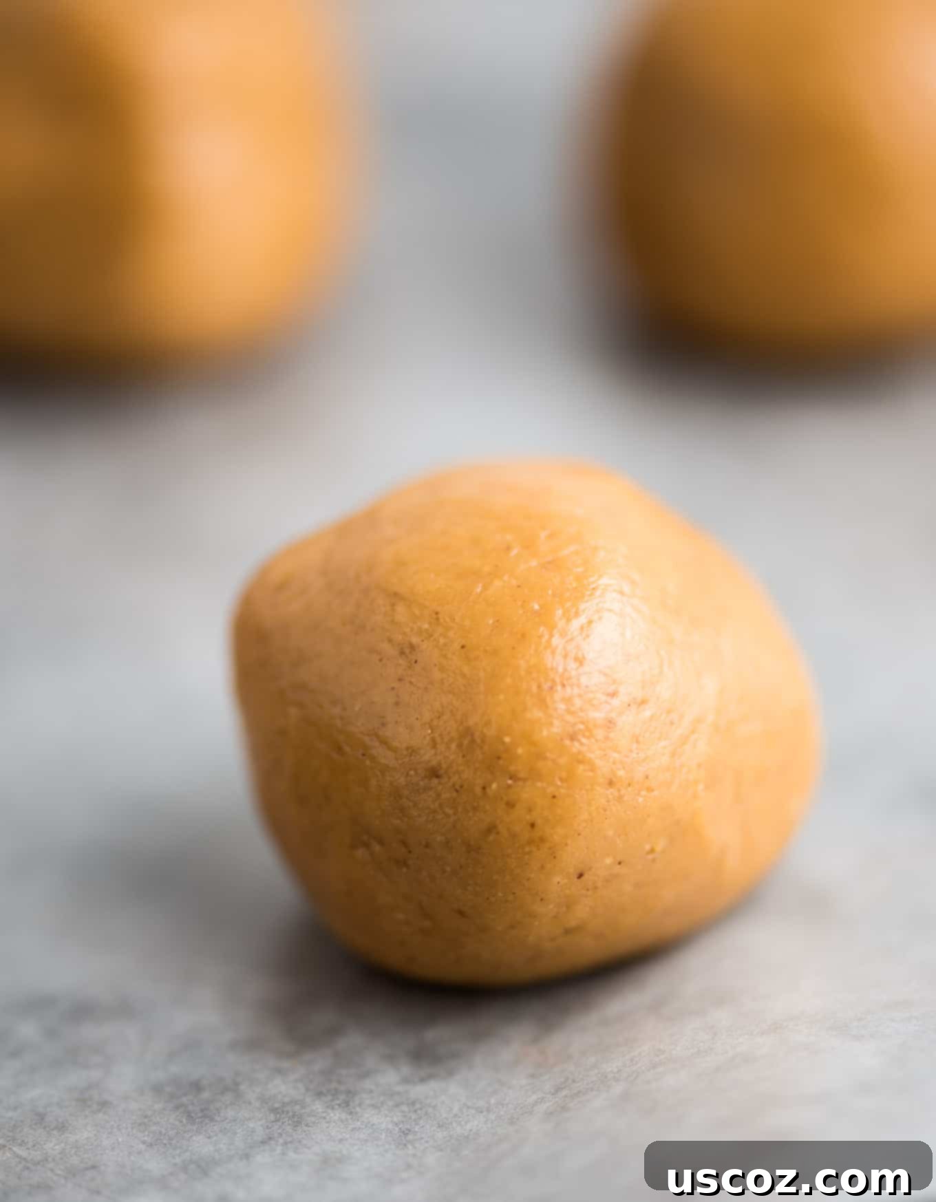 Decadent Yet Healthy No-Bake Peanut Butter Truffles 4 Rolling small, uniform balls of peanut butter mixture on parchment paper.