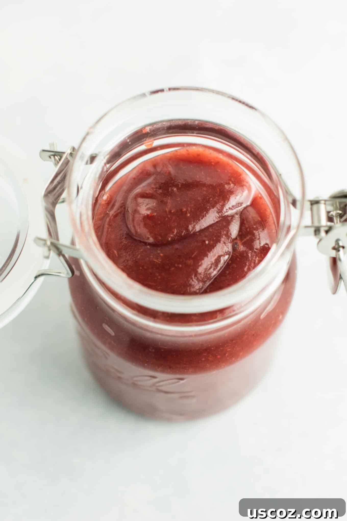 Ultimate Slow Cooker Cranberry Apple Butter 3 Apples and cranberries simmering together in a slow cooker, transforming into a vibrant fruit butter.