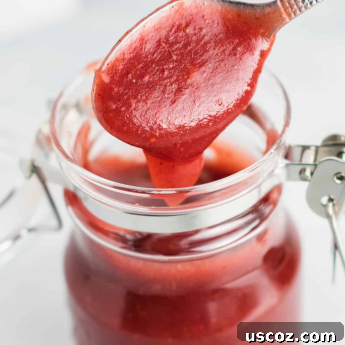 Ultimate Slow Cooker Cranberry Apple Butter 7 A mason jar filled with vibrant homemade cranberry apple butter, perfect for storage or gifting.