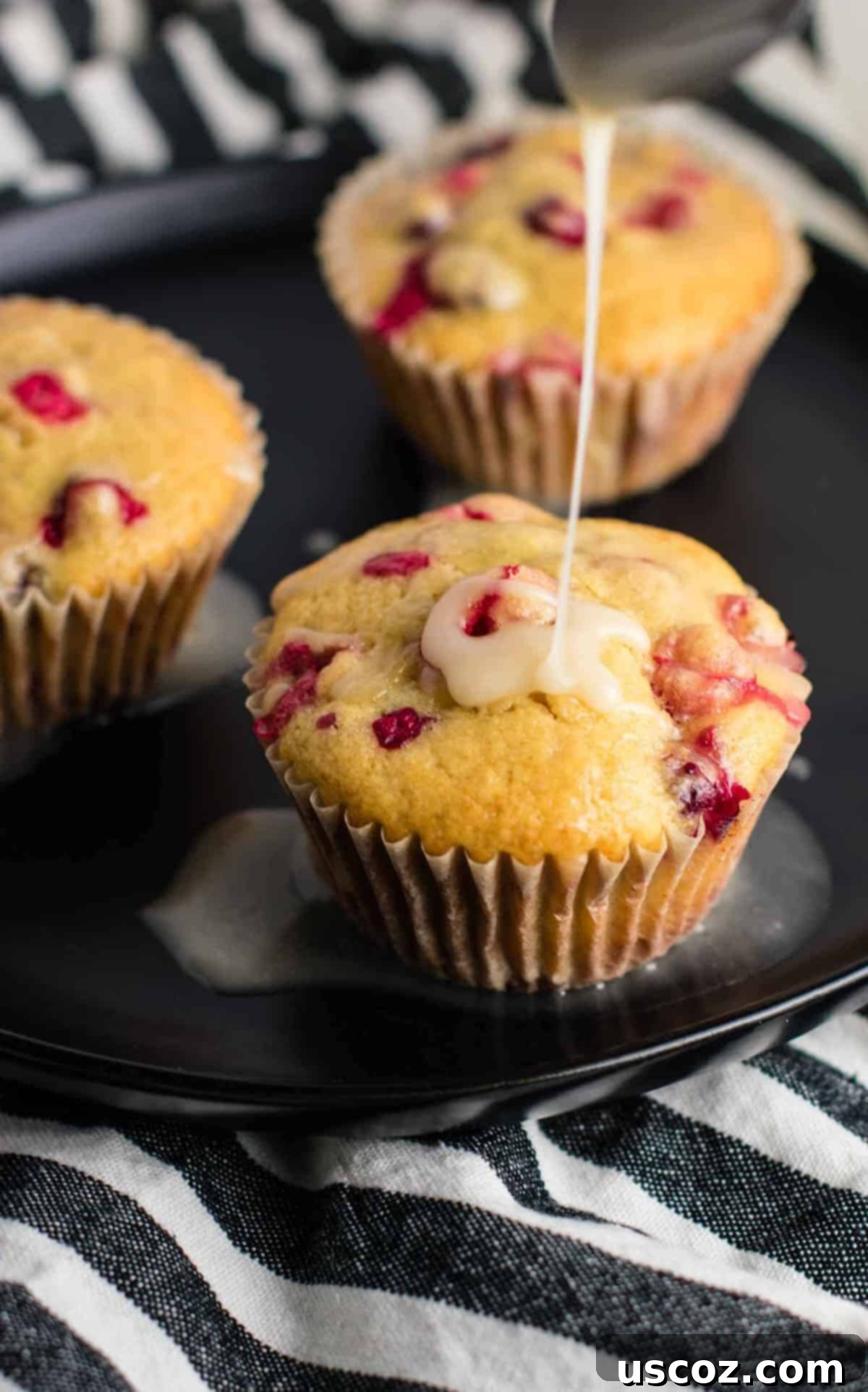 Wholesome Cranberry Orange Muffins 2 Freshly baked healthy cranberry orange muffins with a sweet orange glaze, perfect for breakfast or a snack.