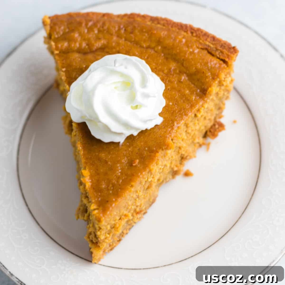 Simple Gluten-Free Pumpkin Pie 3 a slice of pumpkin pie on a plate topped with whipped cream