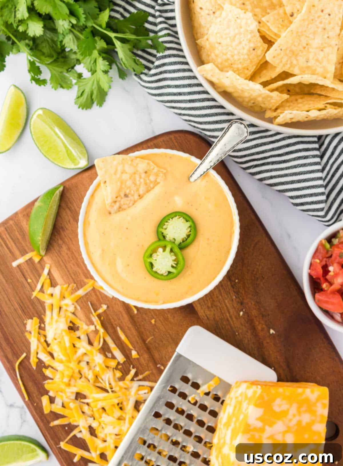 Cheesy Nacho Dip in Minutes 14 nacho cheese sauce in a bowl topped with jalapeno slices