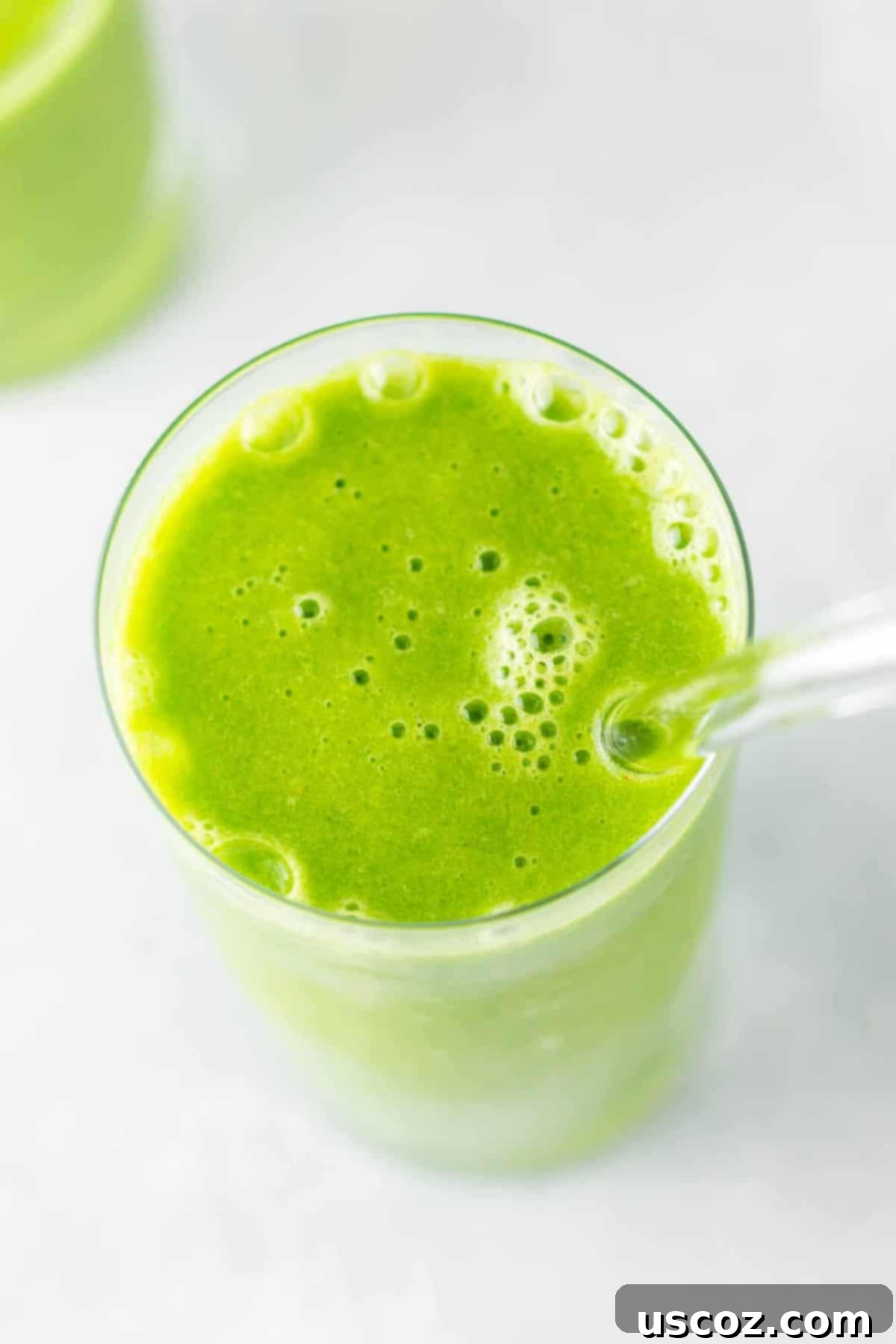 Vibrant Citrus Kale Green Smoothie 2 green smoothie in a glass with a straw