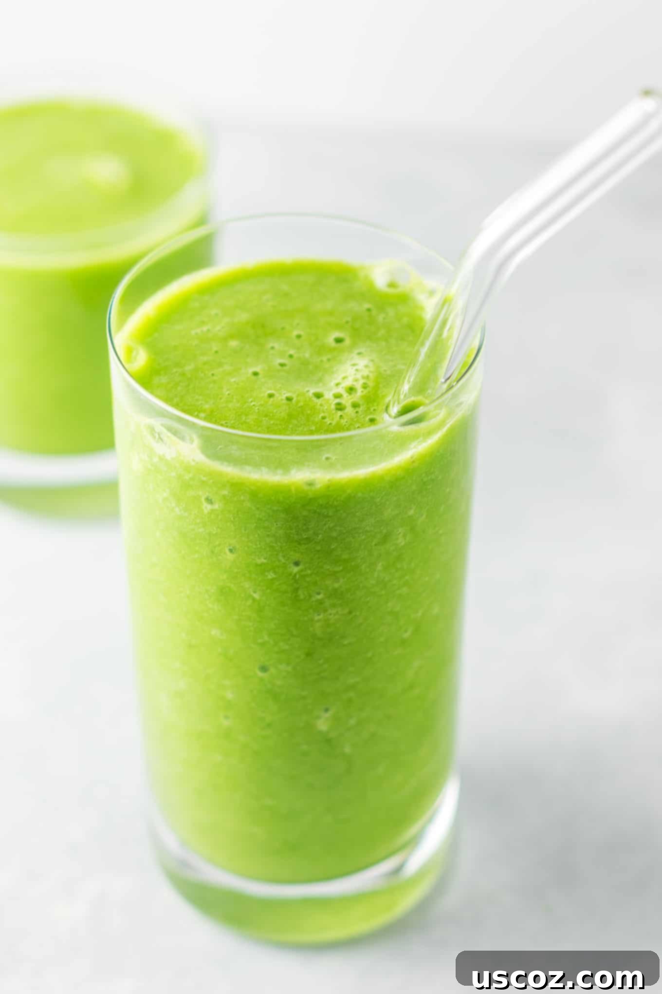 Vibrant Citrus Kale Green Smoothie 8 green smoothie in a glass with a straw