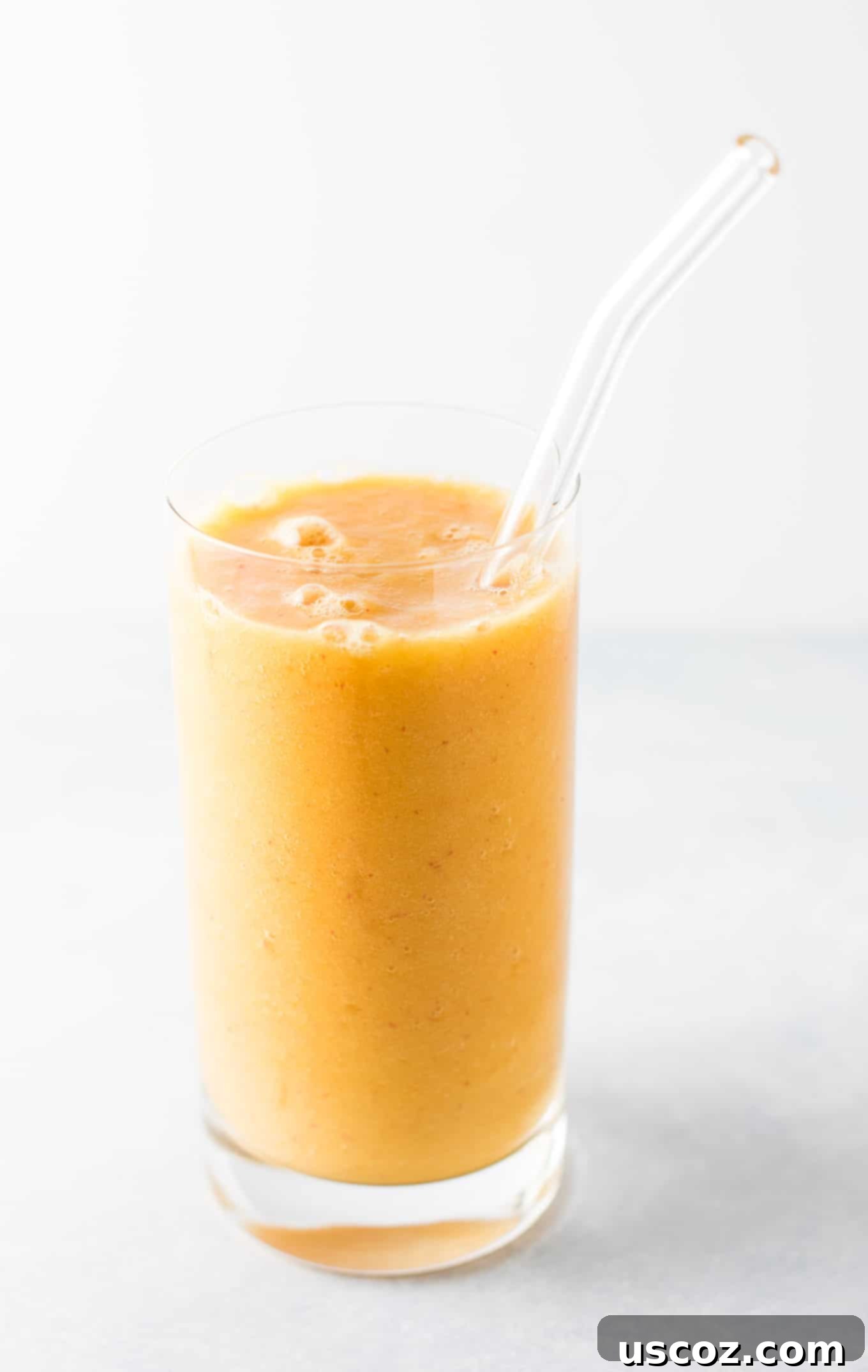 Full pitcher of Ginger Peach Detox Smoothie, ready to be poured. This smoothie is full of healthy ingredients and is naturally vegan. #healthysmoothie #detoxsmoothie #gingerpeachsmoothie #vegan #smoothierecipes