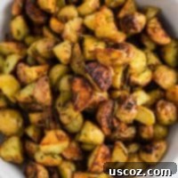 Golden Rosemary Roasted Potatoes 13 A close-up of fragrant rosemary roasted potatoes in a serving bowl, showcasing their golden crispiness.