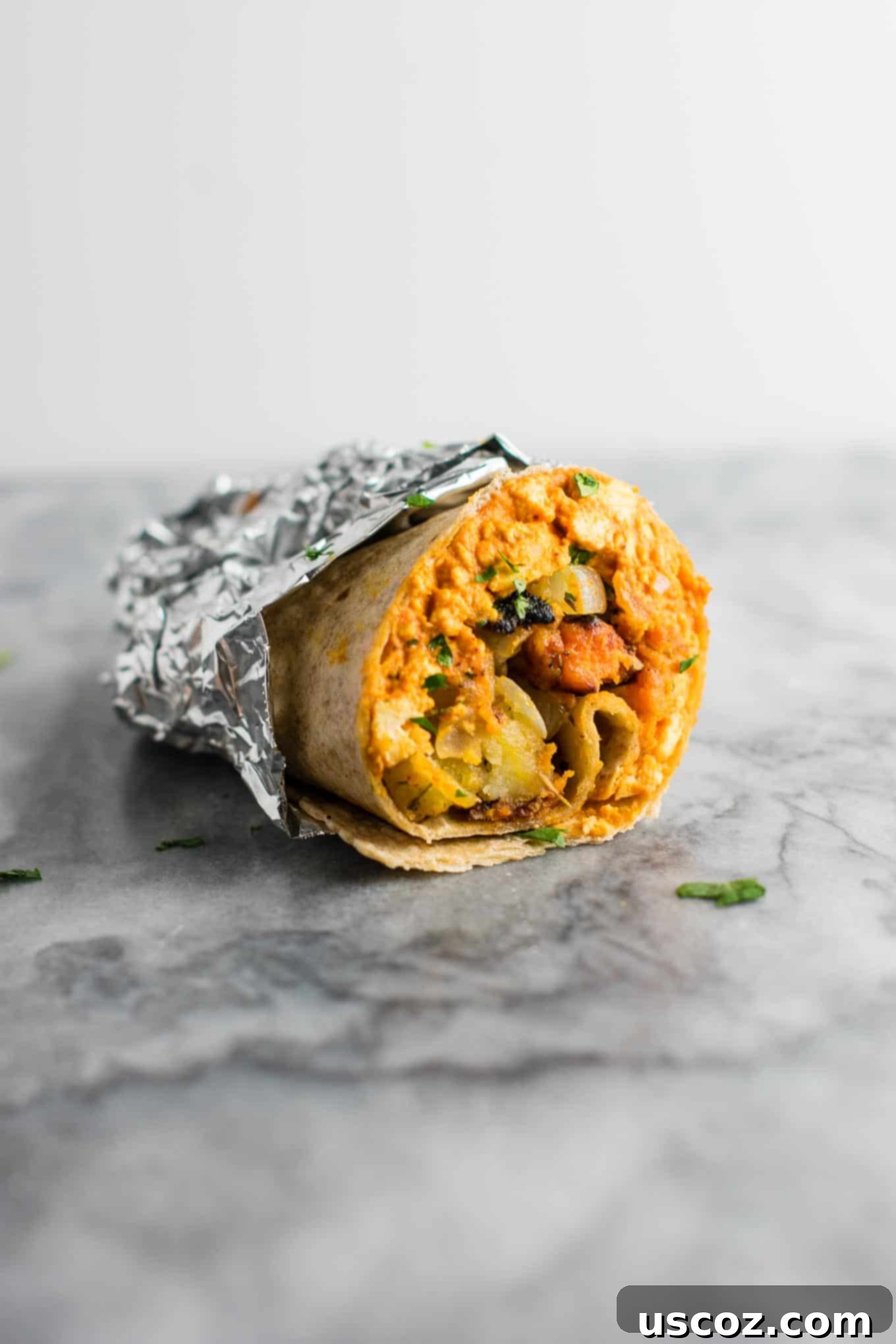 Plant-Based Breakfast Burrito Bliss 3 Two halves of a vegan breakfast burrito showcasing the tofu scramble and crispy hash.