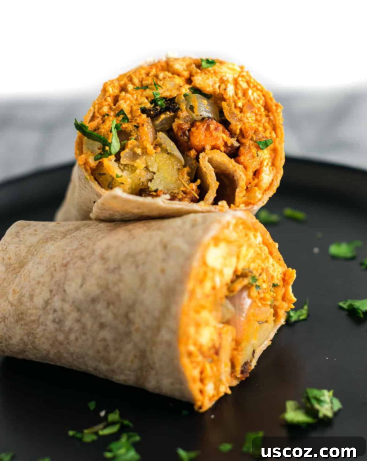 Plant-Based Breakfast Burrito Bliss 8 Two perfectly assembled vegan breakfast burritos, sliced in half and stacked.