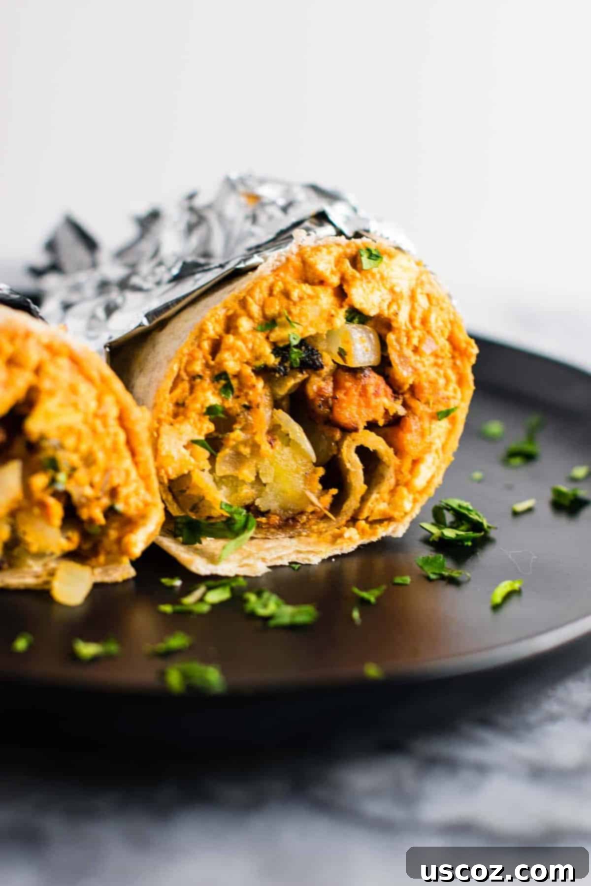 Plant-Based Breakfast Burrito Bliss 10 A batch of freshly made vegan breakfast burritos on a wooden board.