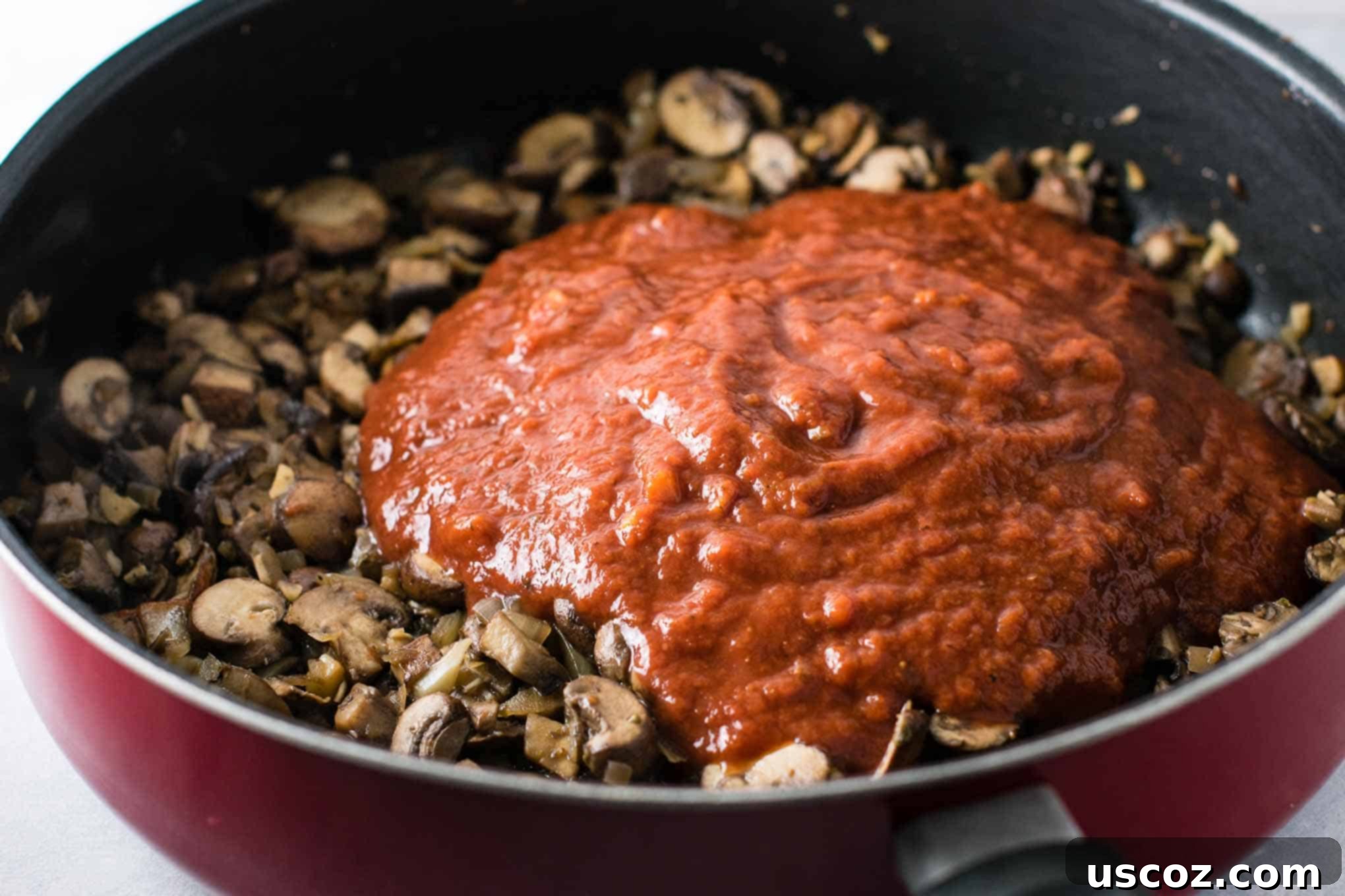 Delicious Vegetarian Spaghetti Sauce 11 pasta sauce on top of the cooked mushrooms