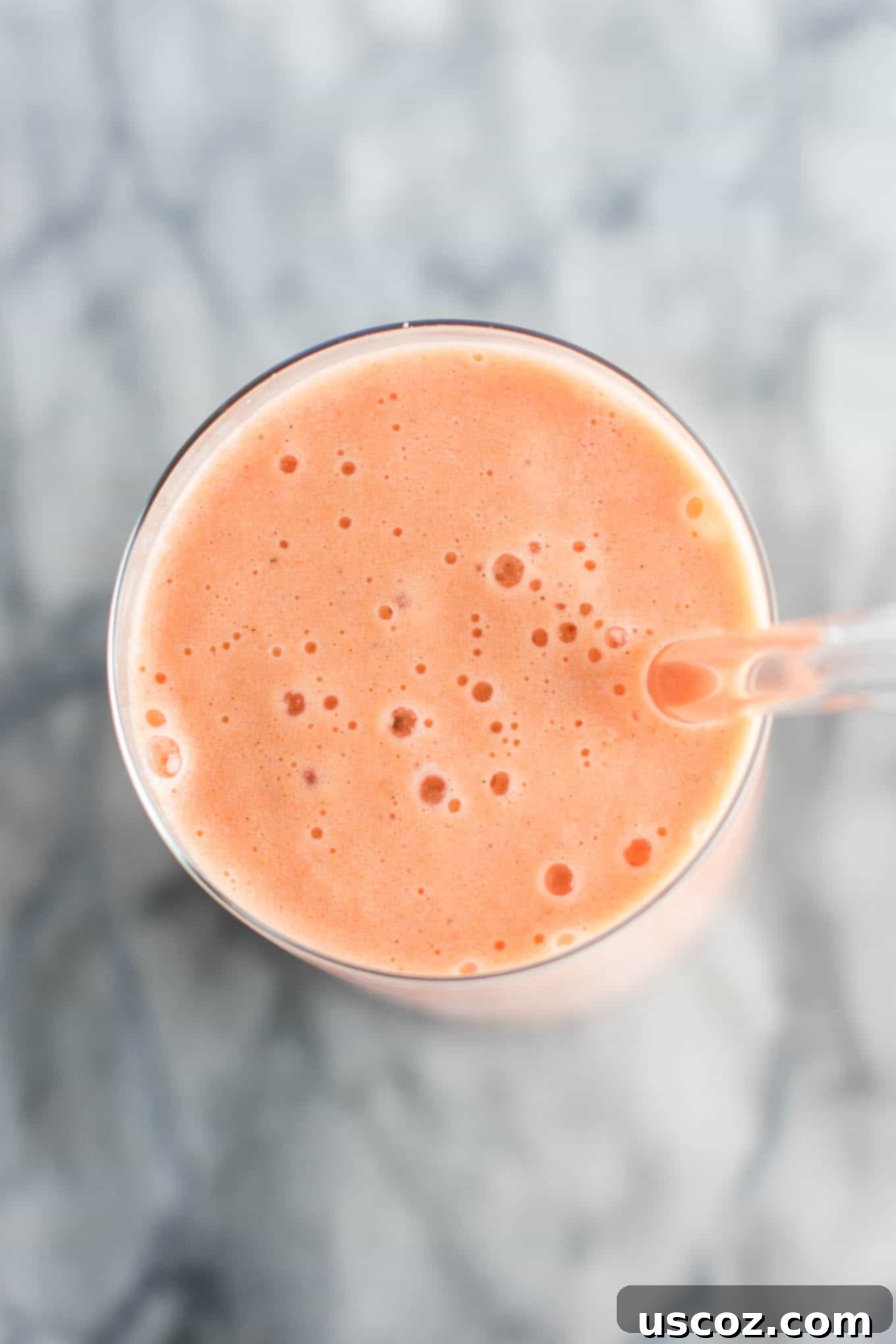 Carrot Cake Dream 4 carrot cake smoothie in a glass with a glass straw