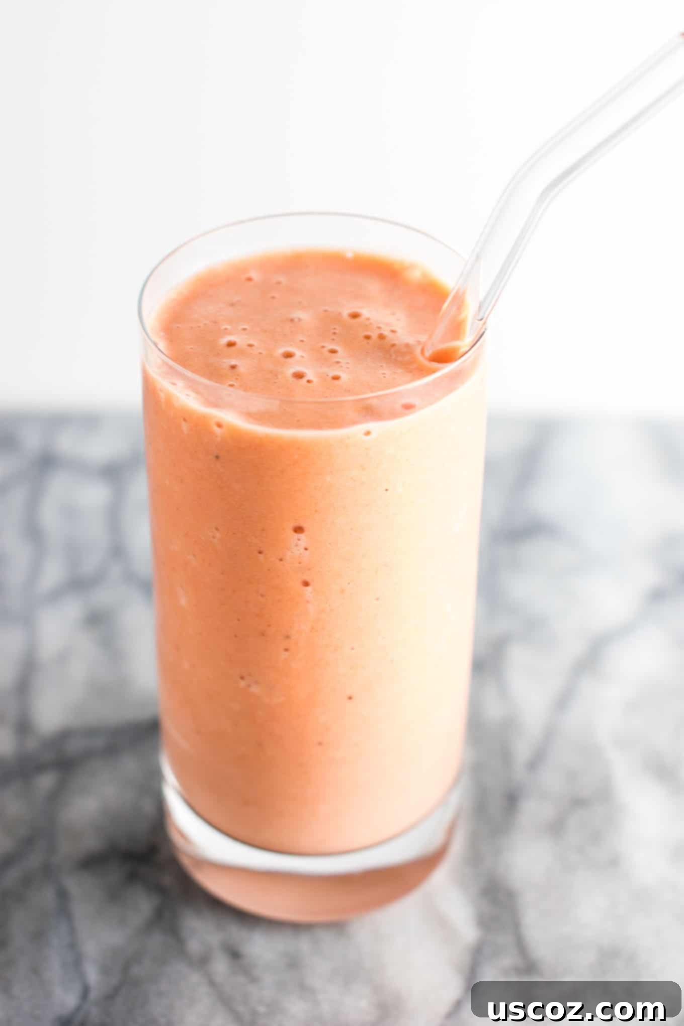 Carrot Cake Dream 8 carrot cake smoothie in a glass with a glass straw