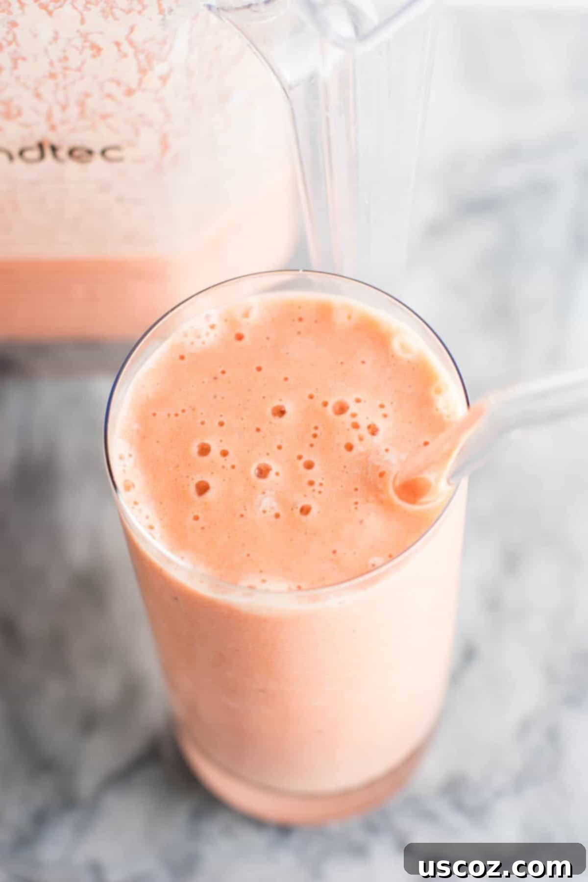 Carrot Cake Dream 10 carrot cake smoothie in a glass with a glass straw